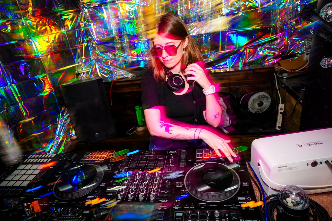 AshWave mixing in front of a holographic backdrop